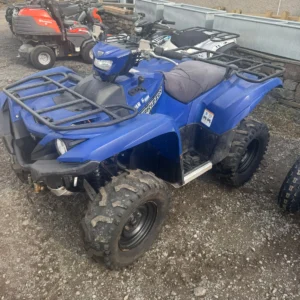 Blue Yamaha Grizzly 700 quad parked on gravel